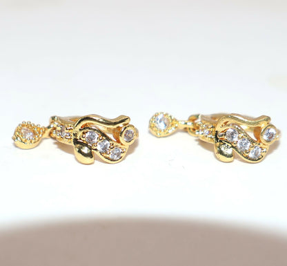 Stacked gold plated Bali style huggie hoop earrings showcasing CZ stones