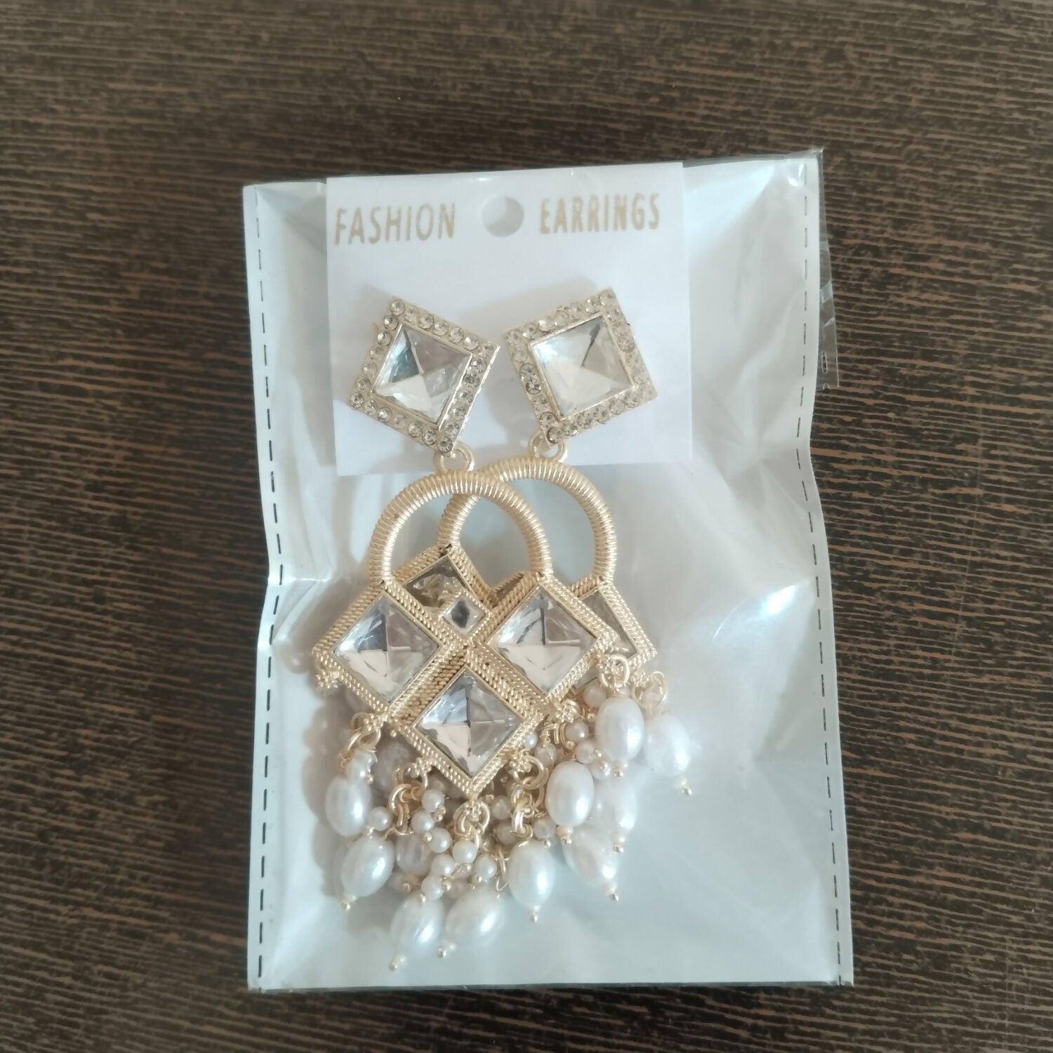 Detailed view of textured arch and micro-pavé accents on Kundan chandelier earrings