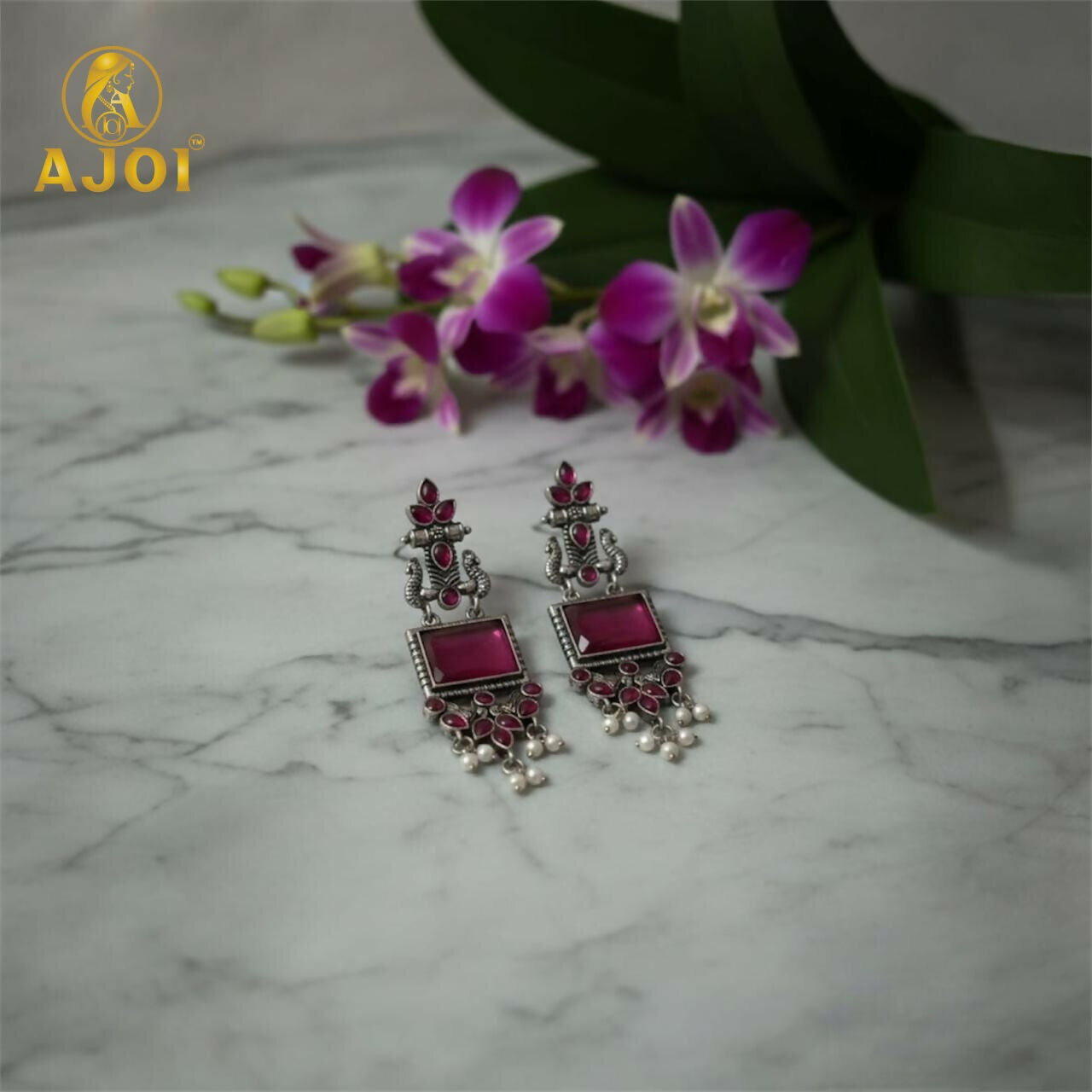 Antique silver earrings showcasing intricate oxidized silver motifs