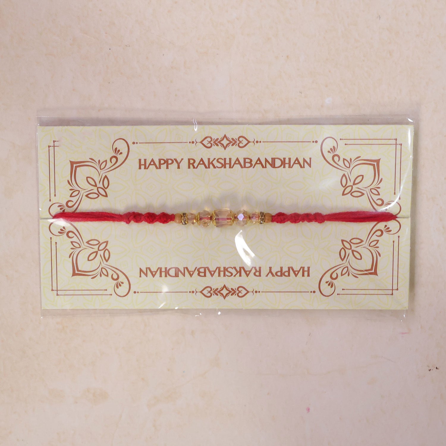 Red Thread Rakhi with Champagne Crystal Beads and Golden Accents
