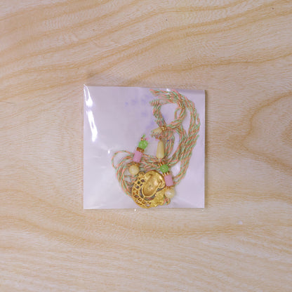 Textured Gold Om Pendant Rakhi with Leaf Accent and Pearl Beads