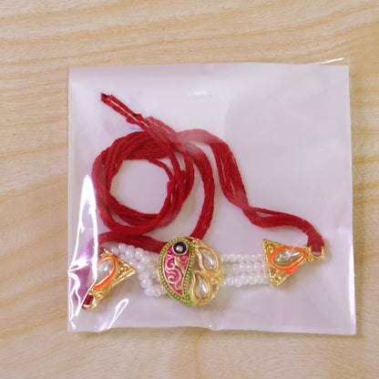 Pearl Paisley Rakhi with Red Thread and Golden Festive Brother Gift Presentation