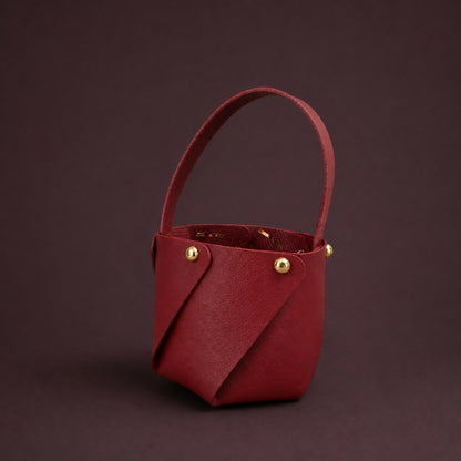 Maroon mini handheld storage basket with handle side angle