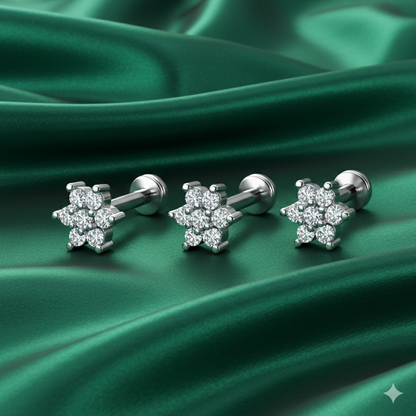 Close-up of silver plated floral crystal nose stud showing six-petal flower design