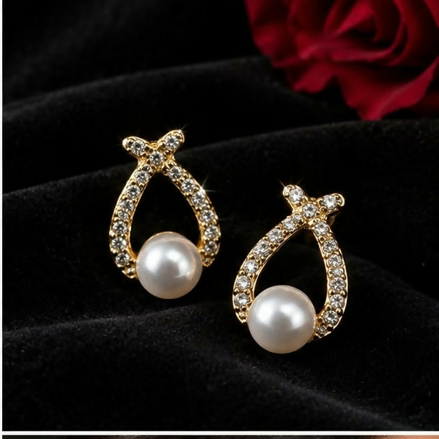 Model wearing gold-tone teardrop earrings with pearl-look beads, highlighting their length