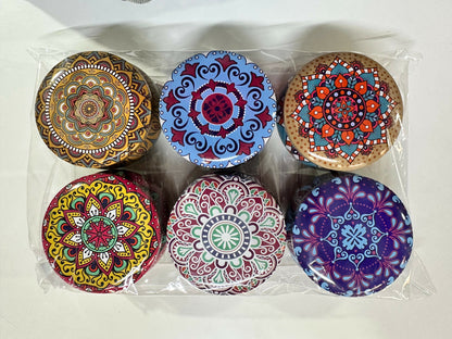 Printed metal storage tin with lid on a wooden surface