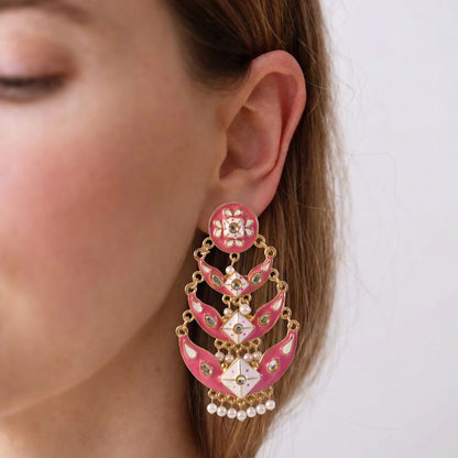 Close-up of pink meenakari chandbali earrings with decorative stones
