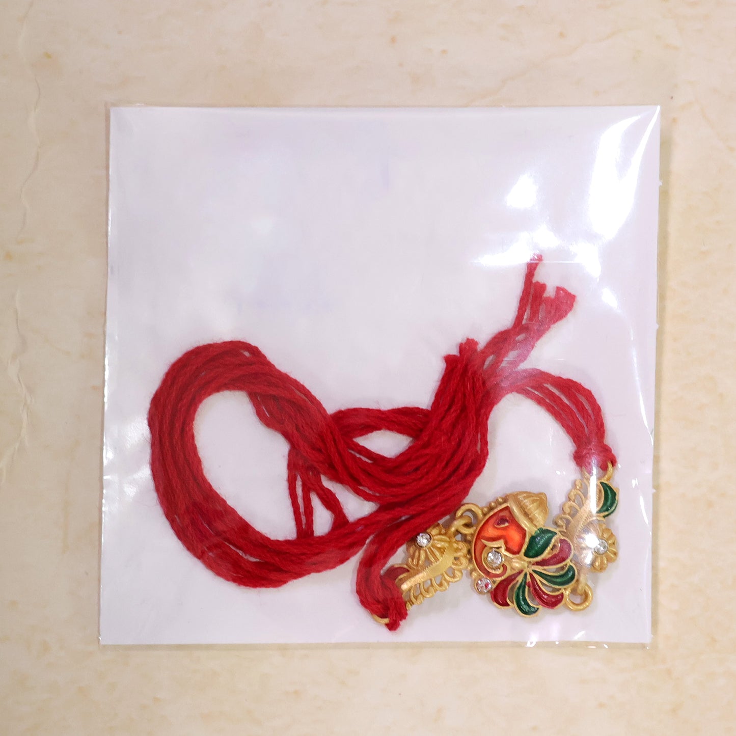 Gold-Toned Lord Ganesha Rakhi with Multicolor Enamel, Crystal Accents & Designer Red Thread