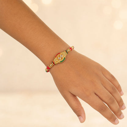 Kundan Cluster Oval Pendant Rakhi with Red and Cream Beads