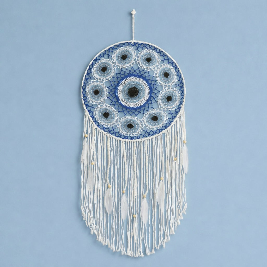 Close-up of woven pattern and feather tassels on dream catcher