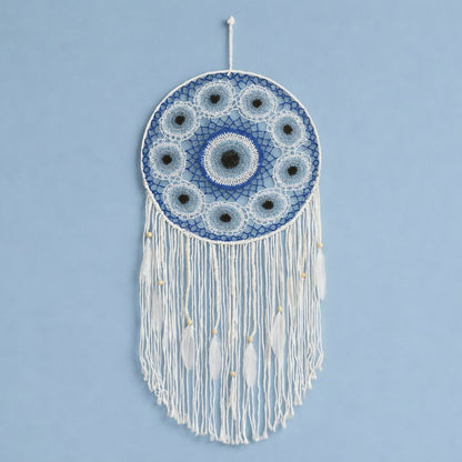 Close-up of woven pattern and feather tassels on dream catcher