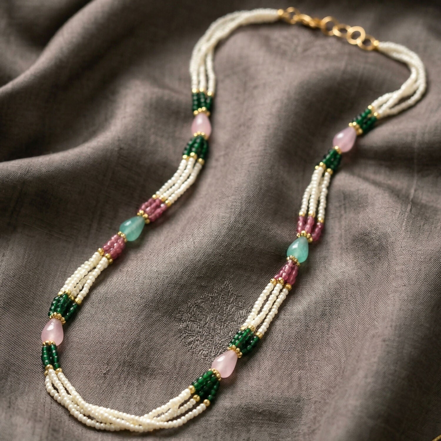 Close-up of multi-layer pearl necklace beads and stones