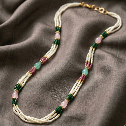 Close-up of multi-layer pearl necklace beads and stones