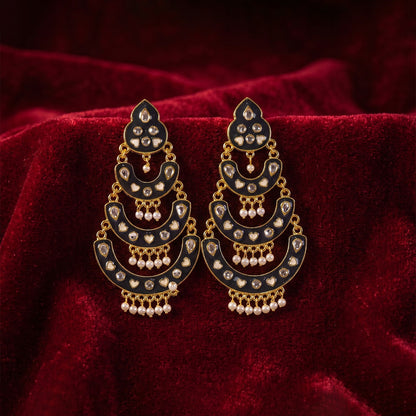Elegant jhumka earrings featuring pink stones and antique gold dome