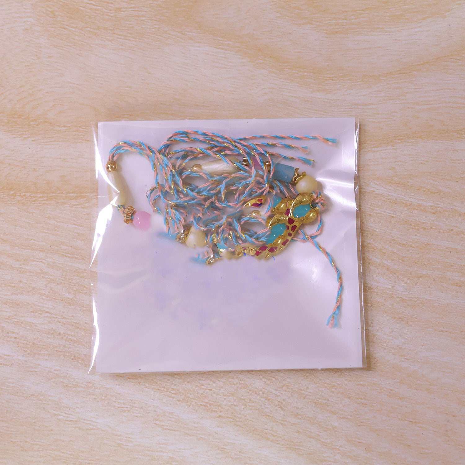 Festive Rakhi with Paisley Heart Charm, blue stones and wrist style for Gift Use