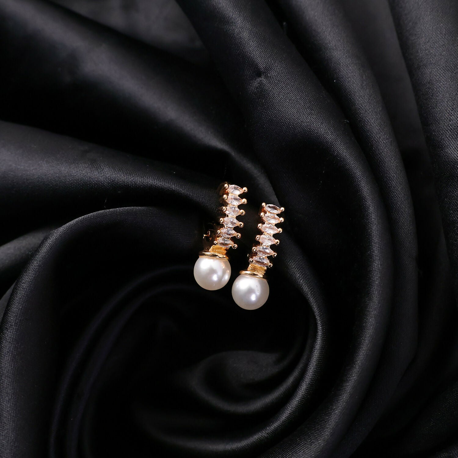 Pearl drop earrings with shiny stones on vertical gold finish bar, styled for formal wear
