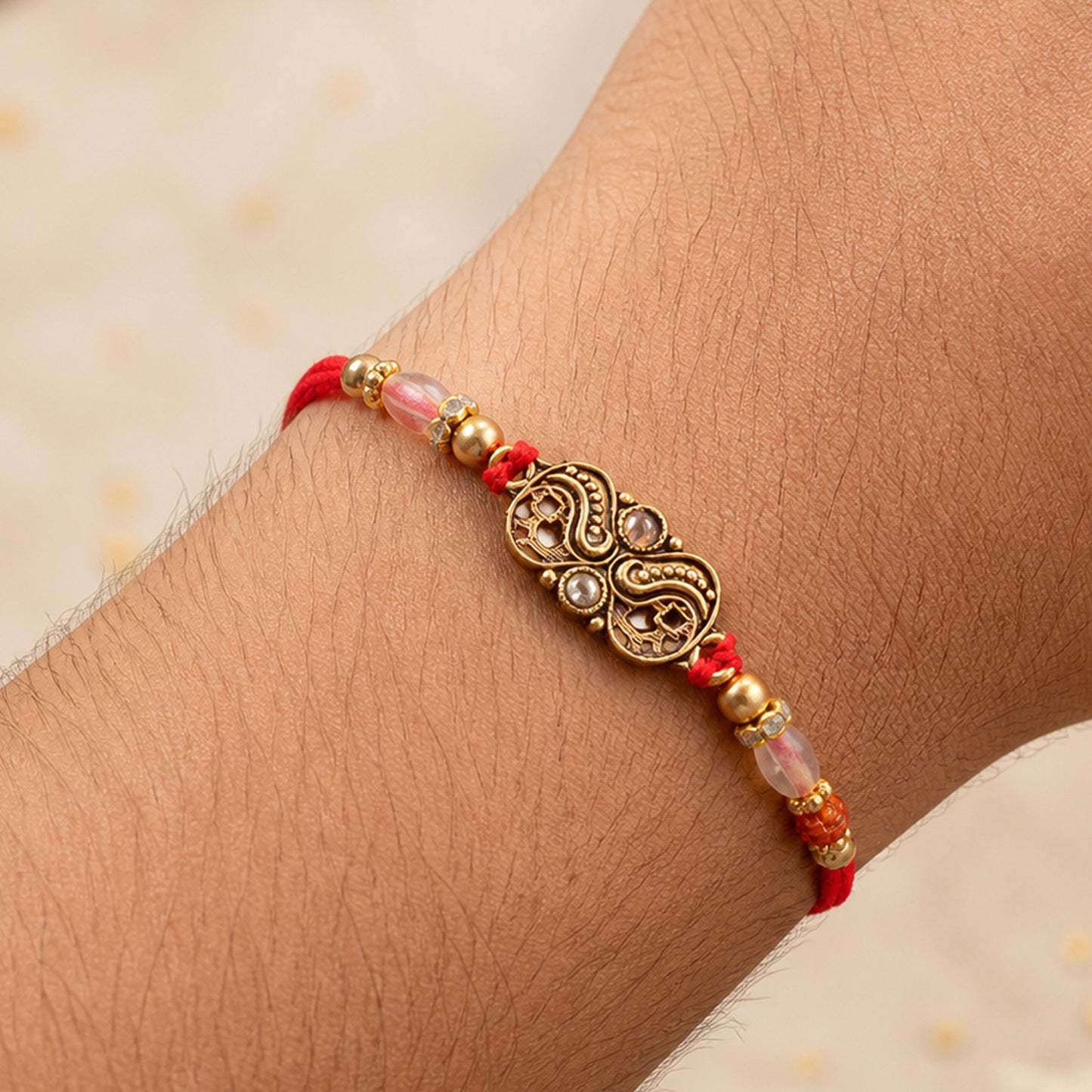 Oxidized Gold Paisley Medallion Rakhi with Rudraksha and Pearl Beads