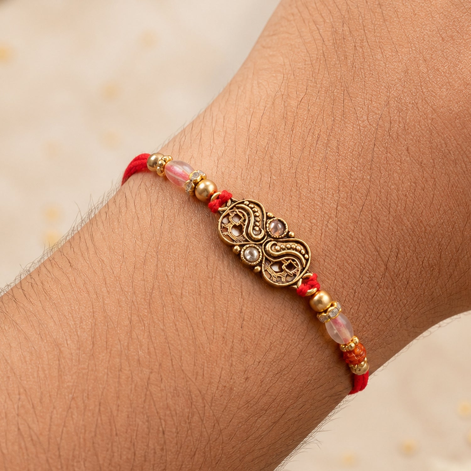 Oxidized Gold Paisley Medallion Rakhi with Rudraksha and Pearl Beads