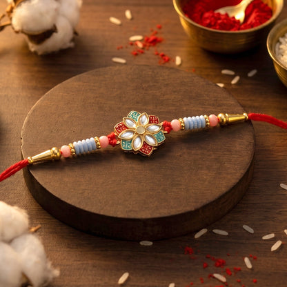 Traditional floral rakhi showcasing intricate kundan work