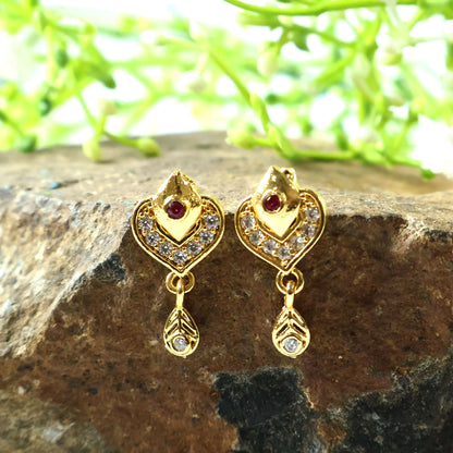Detailed shot of layered heart motif gold drop earrings