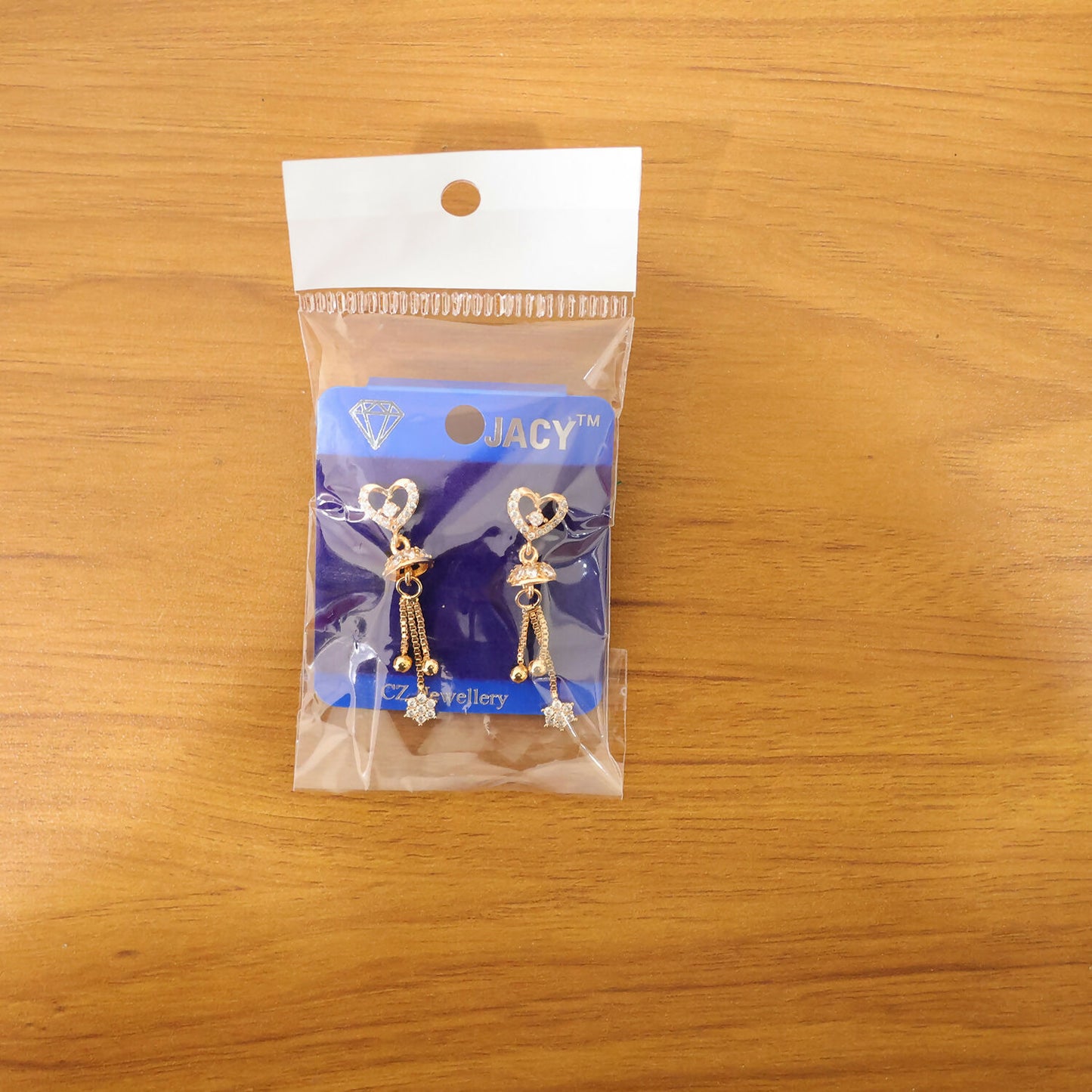 Elegant gold plated double heart crystal drop earrings with star tassel for festive wear