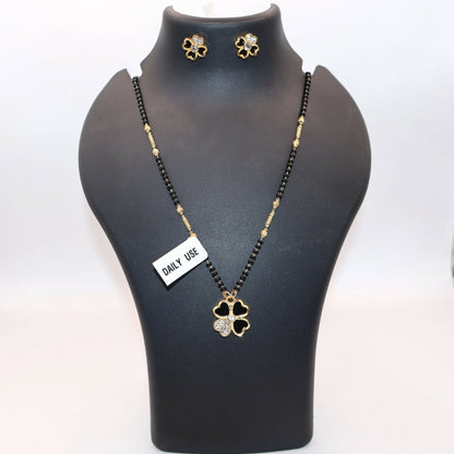 Matching gold-plated stud earrings featuring black clover design