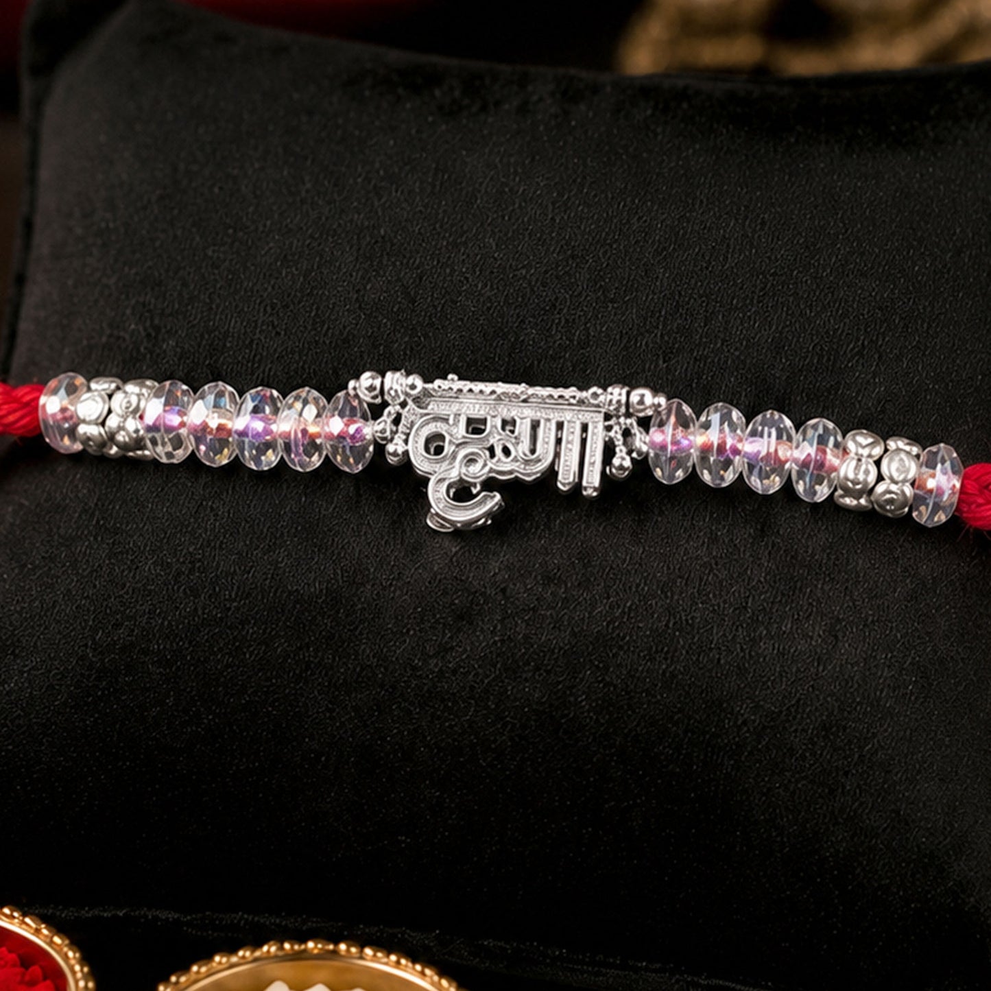 Silver Bhaiya Name Rakhi with Crystal Beads, Red Thread and Sparkling Detail