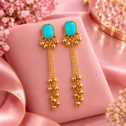 Turquoise Gold Tassel Earrings on Pink Velvet