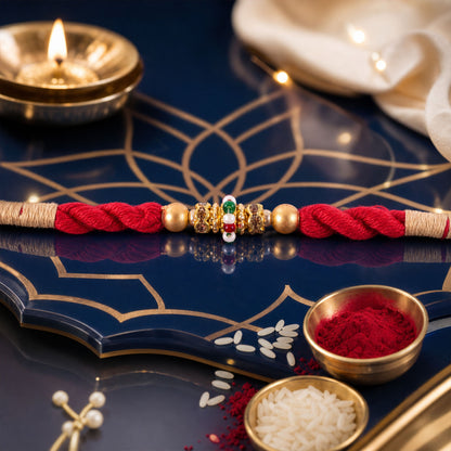 Red Twisted Cord Rakhi with a Colourful Enamel Bead and Gold Accents