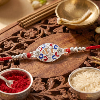 Silver Om Rakhi for Boys with Red Thread and Colorful Accents