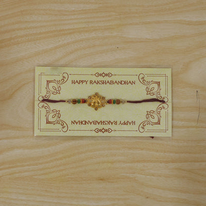 Tilak Trishul Style Devotional Rakhi with Golden Centre and Wooden Beads