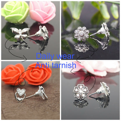 Close-up view of silver plated butterfly stud earrings with crystal accents