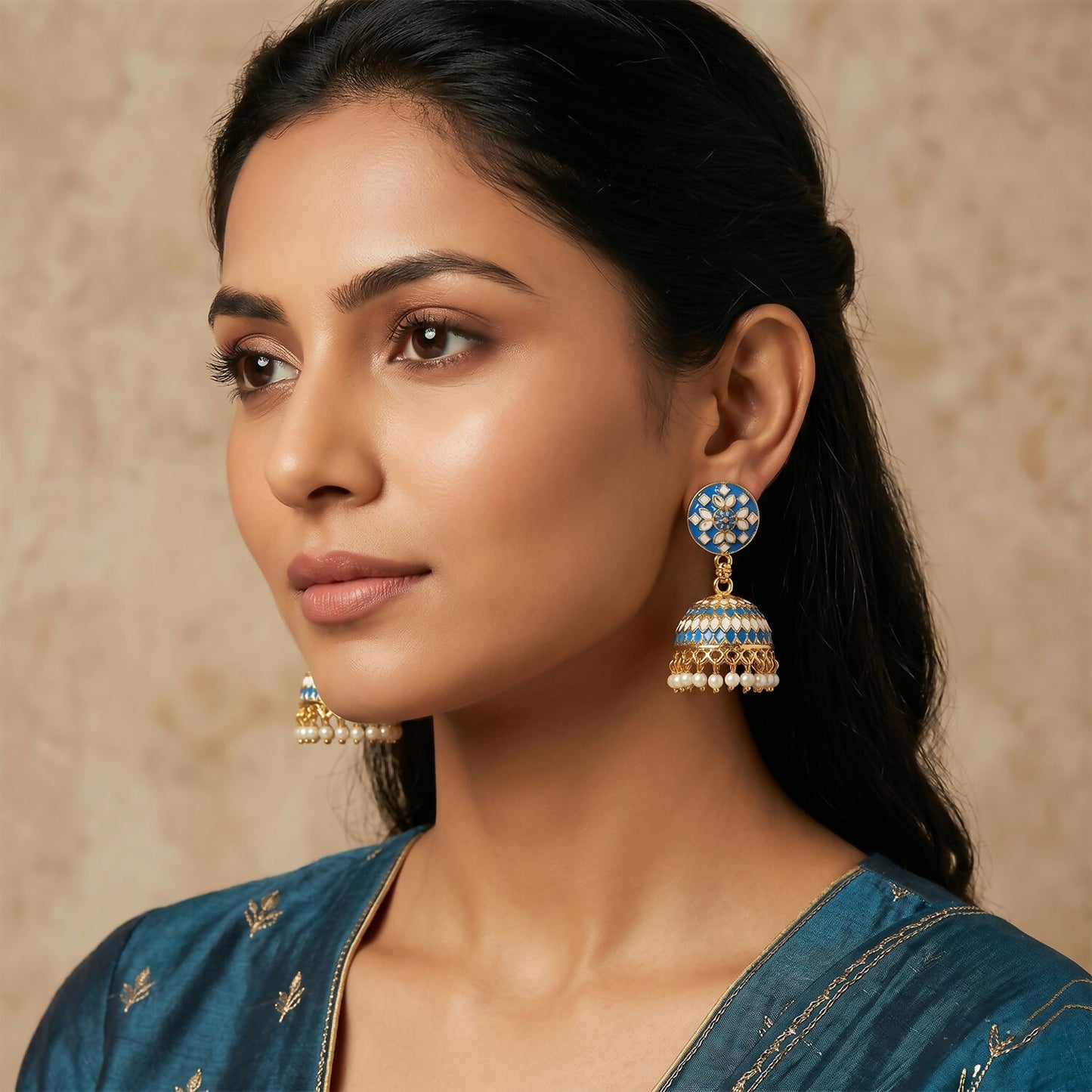 Close-up of decorative dome design on blue jhumka earrings