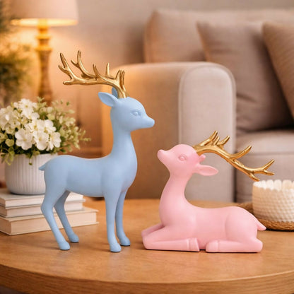 Pastel deer showpiece set with golden antlers on white background