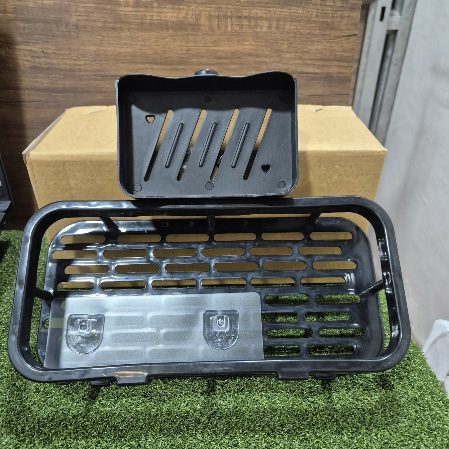 Multipurpose bathroom shelf in use, showing drainage design