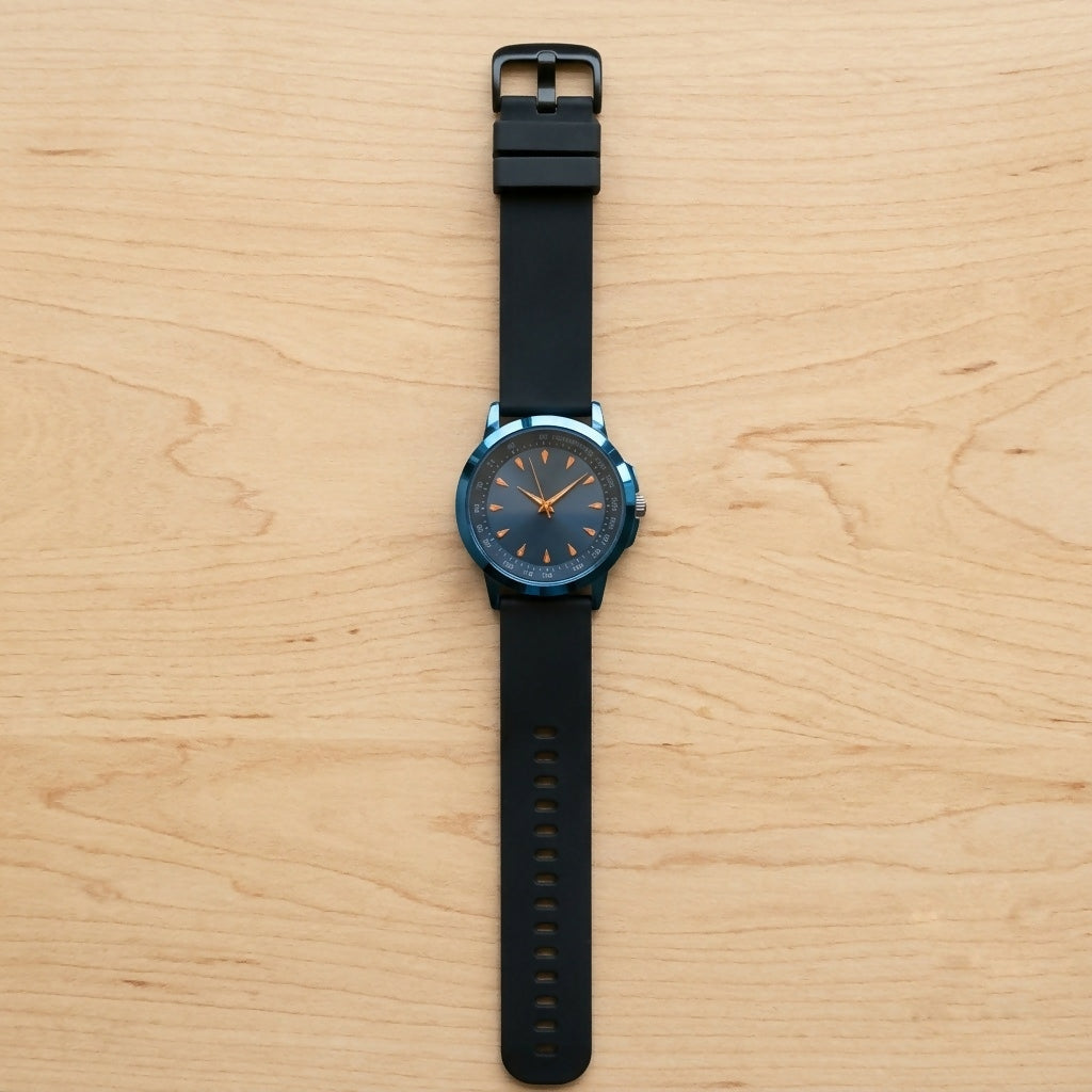 A blue watch with a black strap and golden markers is shown from above on a light wooden surface.