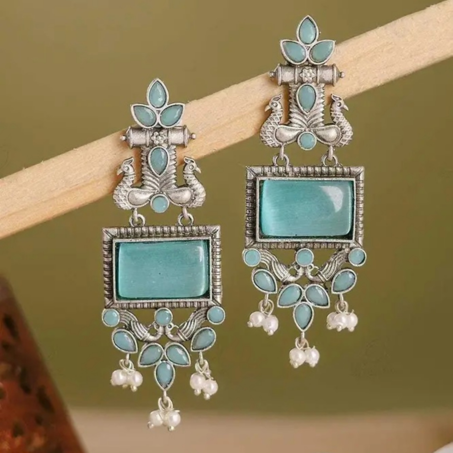 Traditional oxidized silver earrings featuring blue stones and pearl drops