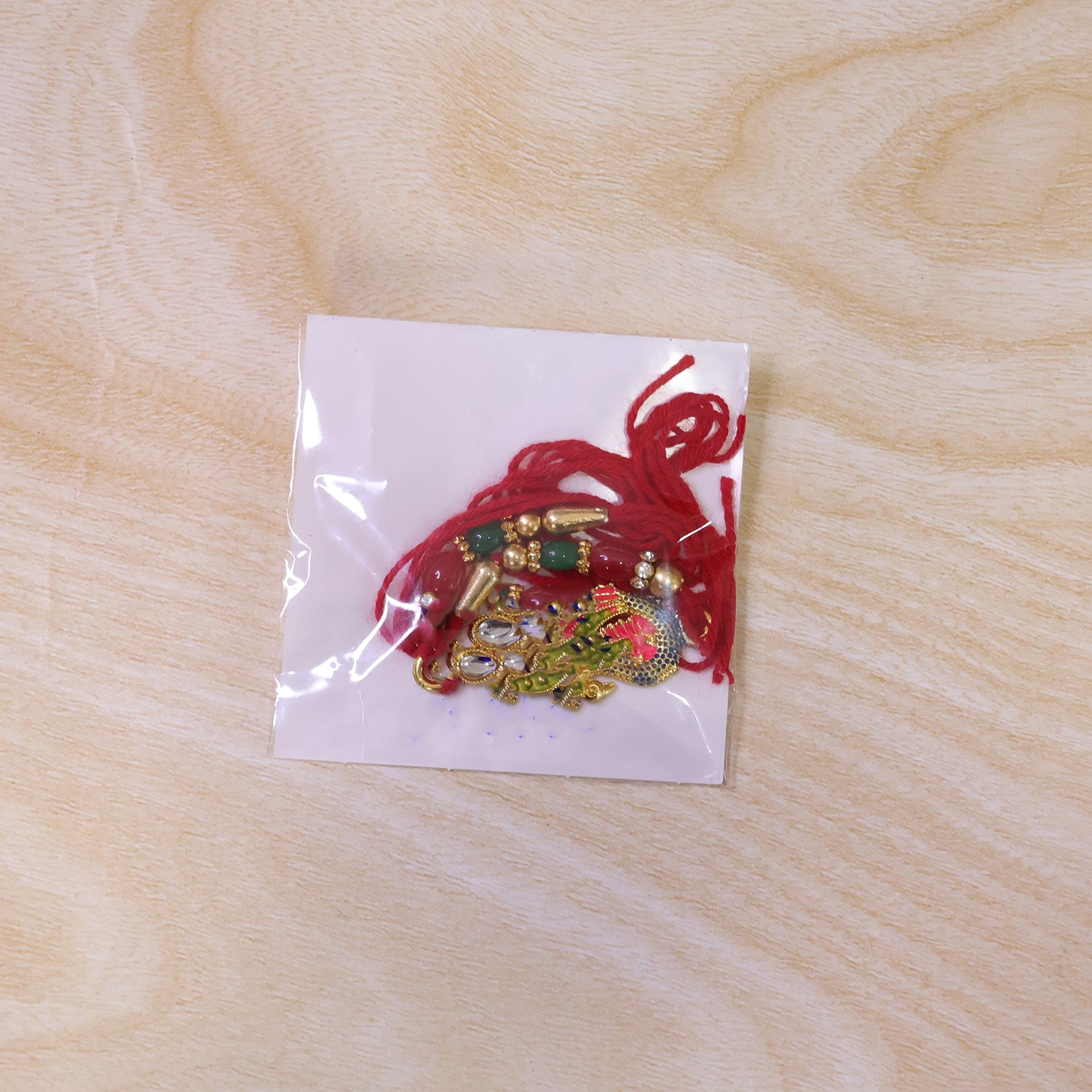 Enamel Peacock Pendant Rakhi with Red and Green Beads