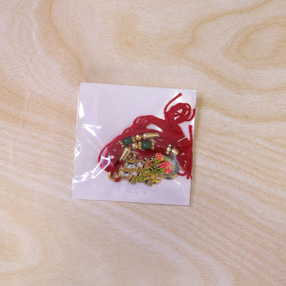 Enamel Peacock Pendant Rakhi with Red and Green Beads