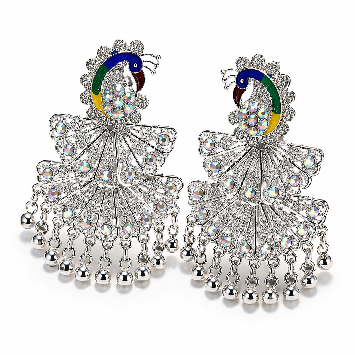 Two ornate silver peacock-shaped earrings with vibrant enamel and numerous clear faceted stones on a white background.