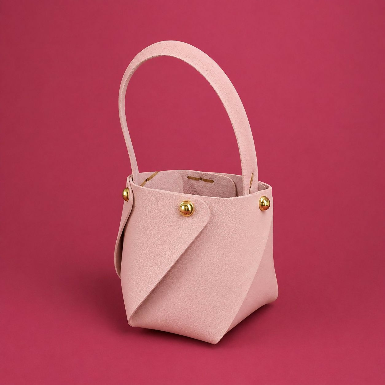 Pink mini bucket handbag open showing interior space