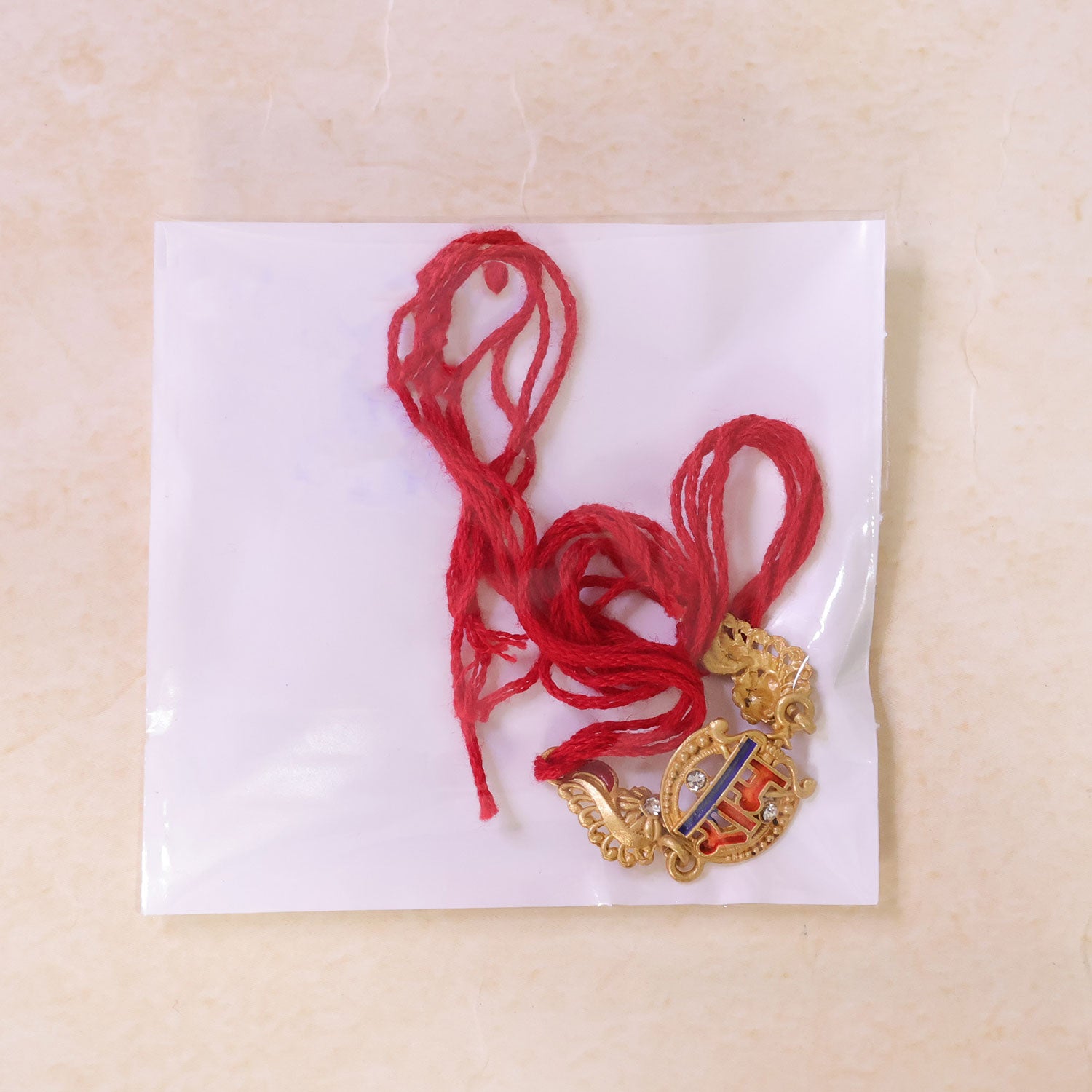 Gold-Toned Ram Rakhi with Orange-Blue Enamel, Crystal Accents & Red Thread