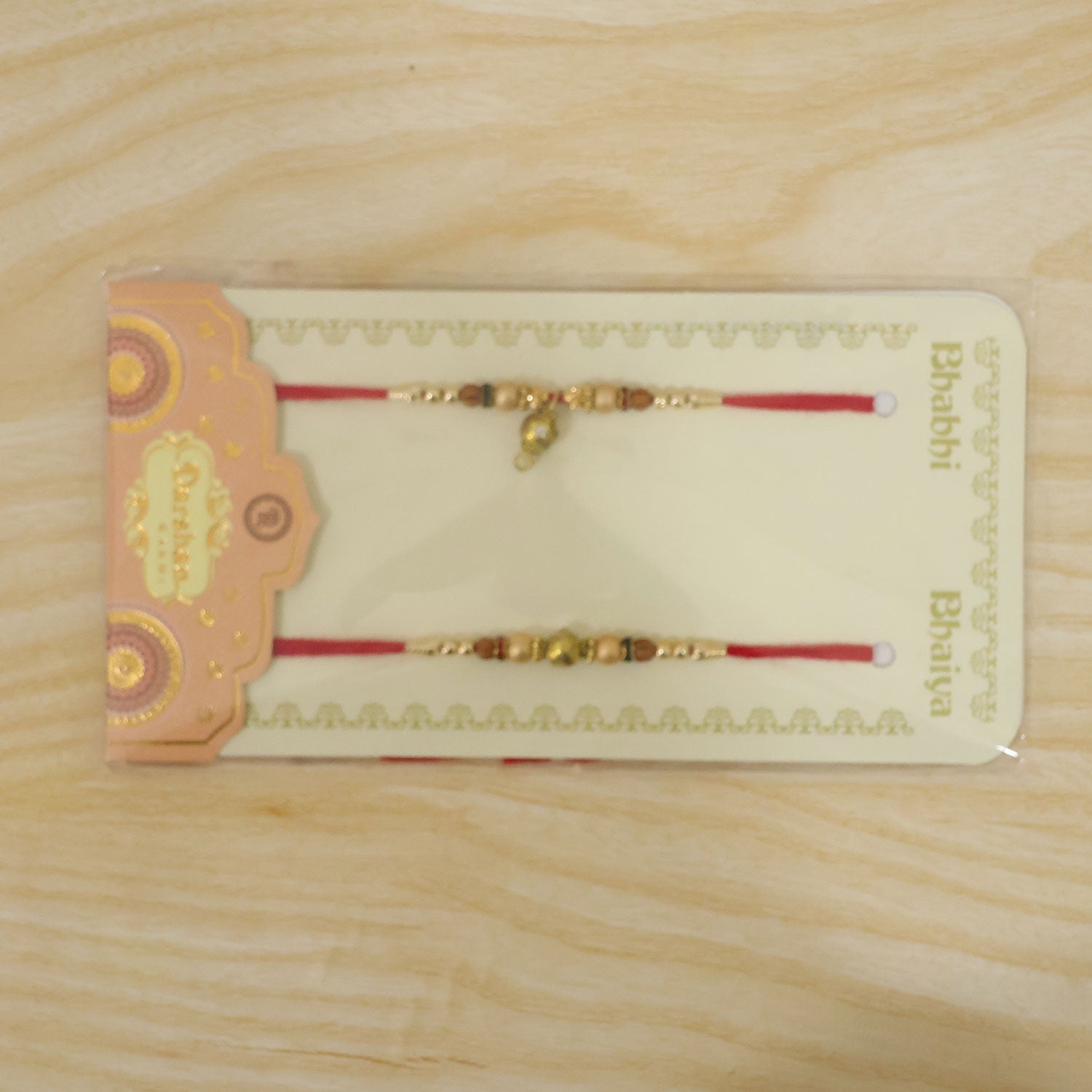 Golden Orb Couple Rakhi Set with Amber Beads and Hanging Charm for Bhaiya Bhabhi