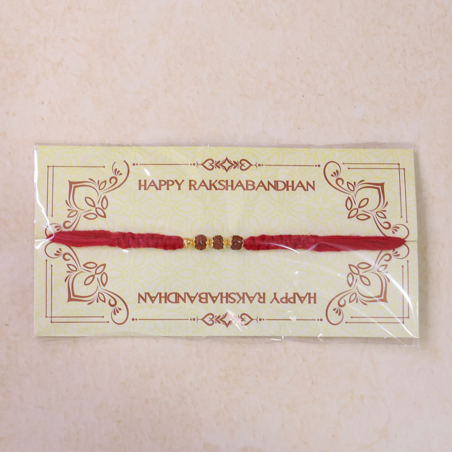 Red Thread Rakhi with a Row of Natural Rudraksha Bead Pendant