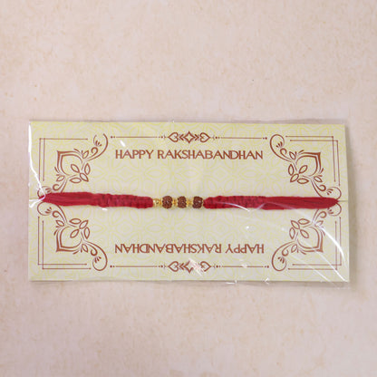 Red Thread Rakhi with a Row of Natural Rudraksha Bead Pendant