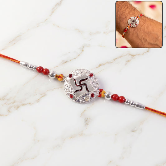 Silver Swastik Stone Rakhi with red thread front view