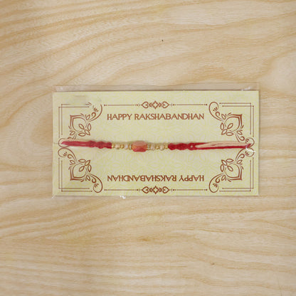 Sparkling Pearl Stone Rakhi with Colorful Thread and Premium Festive Beauty