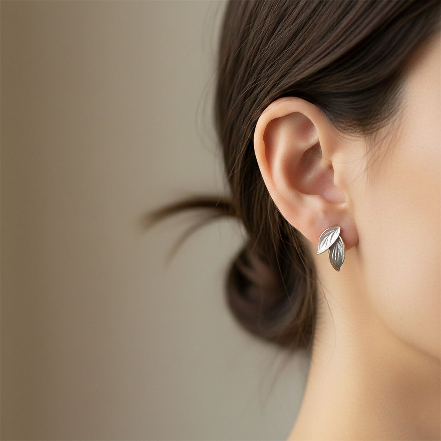 Pearlescent enamel leaf earrings on white background