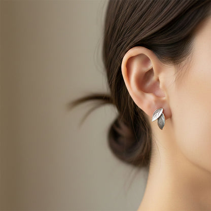 Pearlescent enamel leaf earrings on white background