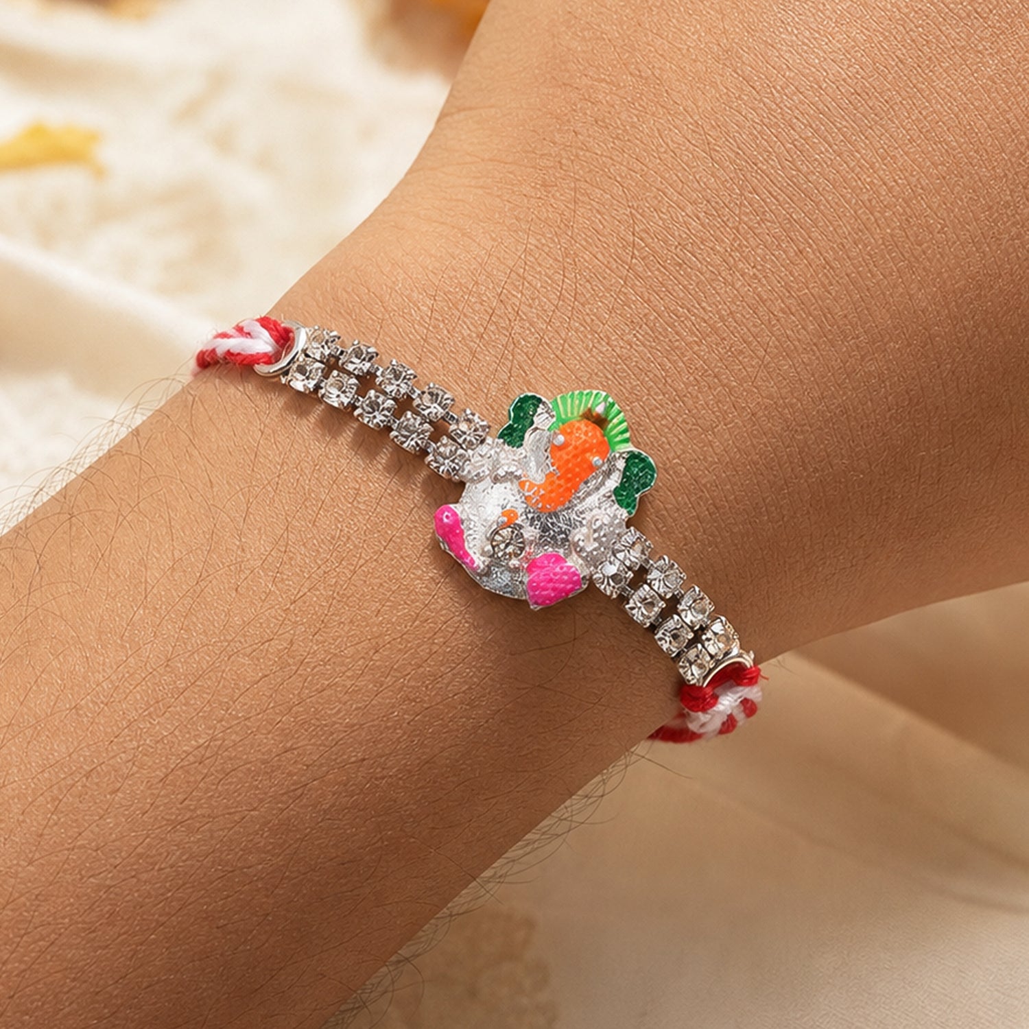 Elegant Rakhi featuring Ganesha Charm, crystal accents and thread style for Gift Use